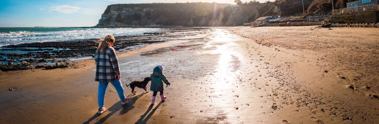 Family walking along the beach in winter